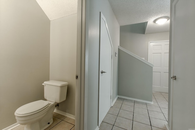 200 Pine Frst Unit F3, Maumelle, AR 72113 - bathroom featuring a textured ceiling, tile patterned flooring, toilet, and baseboards