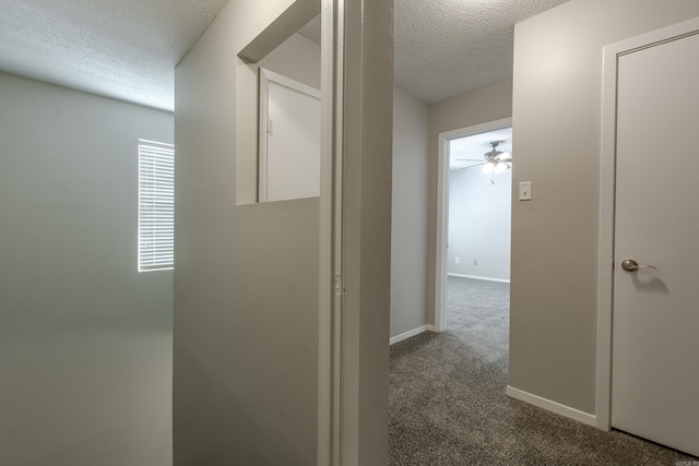 200 Pine Frst Unit F3, Maumelle, AR 72113 - corridor featuring a textured ceiling, dark colored carpet, and baseboards