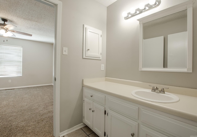 200 Pine Frst Unit F3, Maumelle, AR 72113 - bathroom featuring ceiling fan, a textured ceiling, vanity, and baseboards