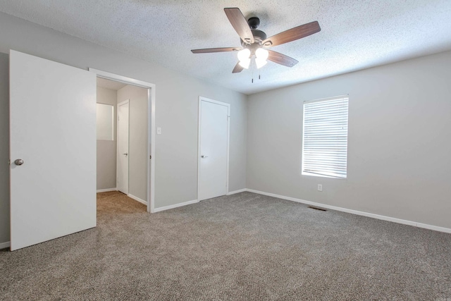 200 Pine Frst Unit F3, Maumelle, AR 72113 - unfurnished bedroom with carpet, baseboards, a ceiling fan, and a textured ceiling