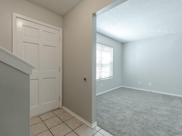 200 Pine Frst Unit F3, Maumelle, AR 72113 - foyer entrance featuring a textured ceiling, light tile patterned flooring, and baseboards