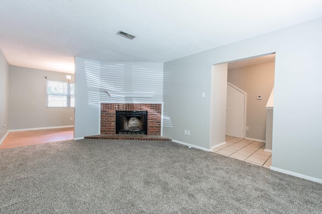 200 Pine Frst Unit F3, Maumelle, AR 72113 - unfurnished living room with light colored carpet, a brick fireplace, and baseboards