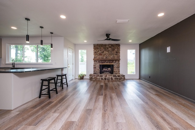 1117 Wild Turkey Ct, Little Rock, AR 72211 - living area featuring wood finished floors, a ceiling fan, recessed lighting, and a stone fireplace