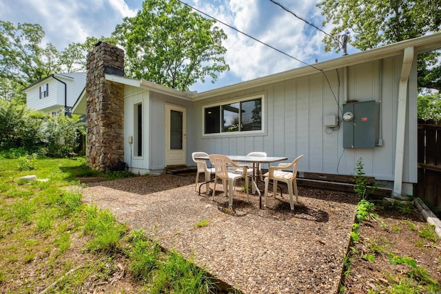 1117 Wild Turkey Ct, Little Rock, AR 72211 - rear view of property featuring a chimney, outdoor dining space, and a patio