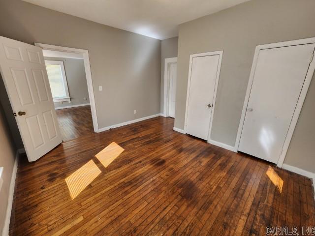 3716 Marion St, North Little Rock, AR 72118 - unfurnished bedroom with hardwood / wood-style flooring and baseboards