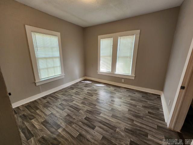 3716 Marion St, North Little Rock, AR 72118 - unfurnished room featuring plenty of natural light, dark wood finished floors, and baseboards
