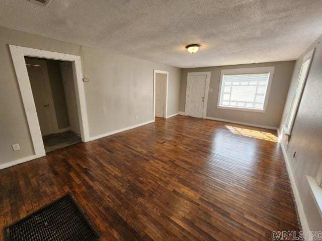 3716 Marion St, North Little Rock, AR 72118 - spare room featuring wood finished floors, a textured ceiling, and baseboards