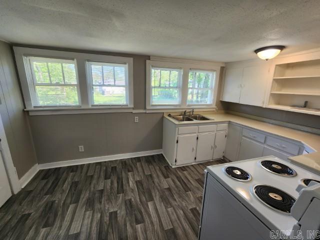 3716 Marion St, North Little Rock, AR 72118 - kitchen with electric range, a sink, a textured ceiling, white cabinets, and dark wood finished floors