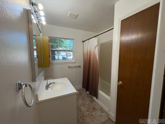 4900 Lochridge Rd, North Little Rock, AR 72116 - full bath with vanity, tile patterned floors, and shower / bath combination with curtain