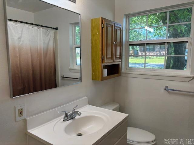 4900 Lochridge Rd, North Little Rock, AR 72116 - bathroom with healthy amount of natural light, toilet, and vanity