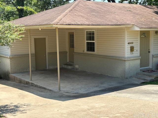 4900 Lochridge Rd, North Little Rock, AR 72116 - view of front of house featuring entry steps, driveway, and a carport
