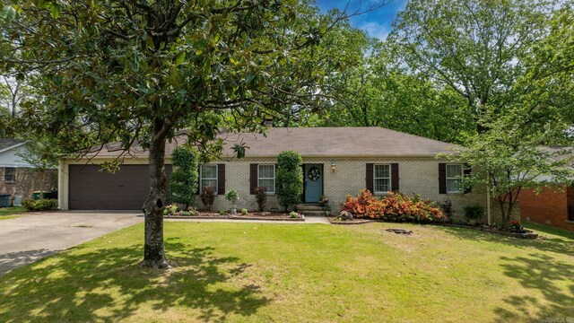 3016 Cleburne Pl, North Little Rock, AR 72116 - ranch-style home featuring brick siding, concrete driveway, a front lawn, and an attached garage