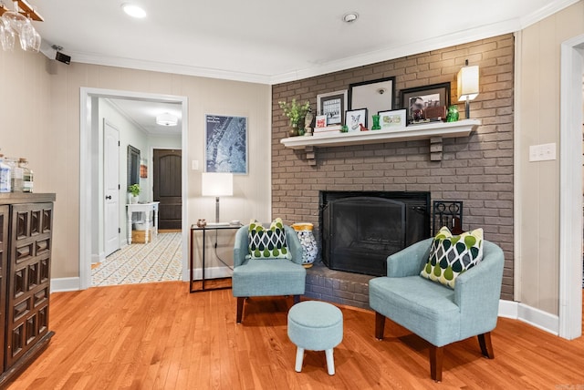3016 Cleburne Pl, North Little Rock, AR 72116 - living area featuring crown molding, light wood-type flooring, a fireplace, baseboards, and a decorative wall