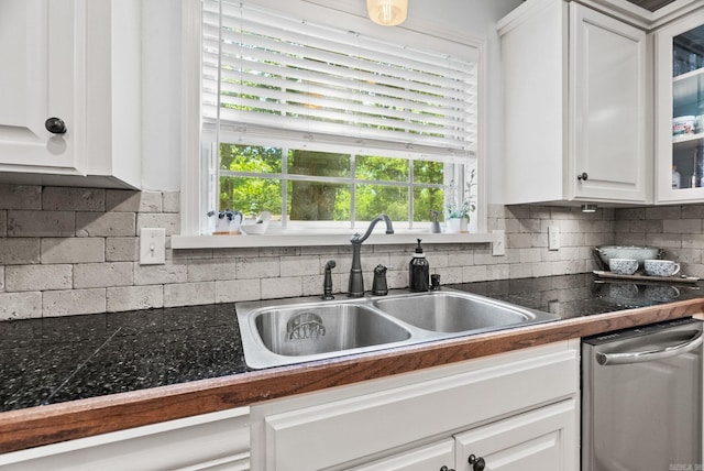 3016 Cleburne Pl, North Little Rock, AR 72116 - kitchen with a sink, white cabinetry, decorative backsplash, glass insert cabinets, and dishwasher
