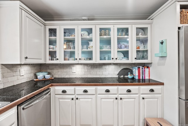 3016 Cleburne Pl, North Little Rock, AR 72116 - kitchen with stainless steel appliances, tile counters, white cabinetry, glass insert cabinets, and crown molding