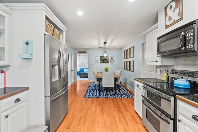 3016 Cleburne Pl, North Little Rock, AR 72116 - kitchen with stainless steel appliances, white cabinetry, tasteful backsplash, glass insert cabinets, and recessed lighting