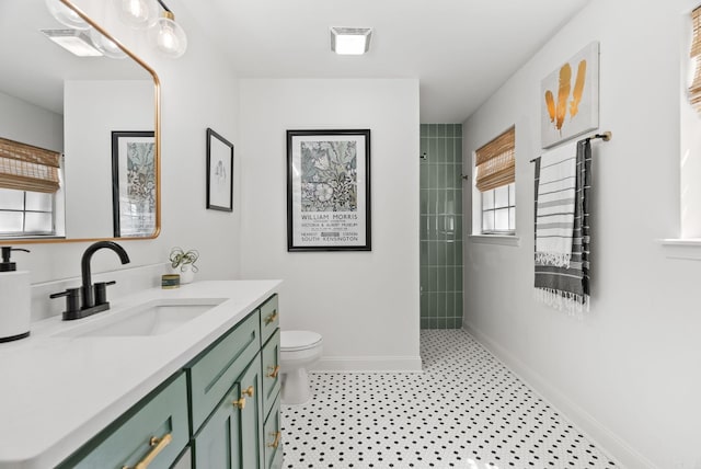 3016 Cleburne Pl, North Little Rock, AR 72116 - bathroom featuring baseboards, a tile shower, toilet, and vanity