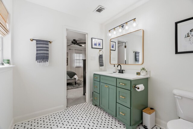 3016 Cleburne Pl, North Little Rock, AR 72116 - ensuite bathroom featuring toilet, baseboards, vanity, and ceiling fan