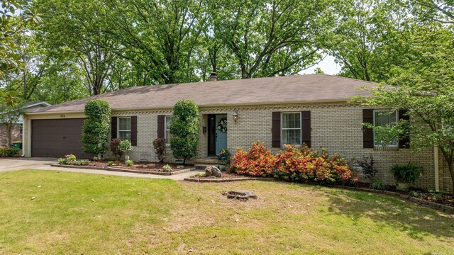 3016 Cleburne Pl, North Little Rock, AR 72116 - single story home with brick siding, an attached garage, concrete driveway, and a front lawn