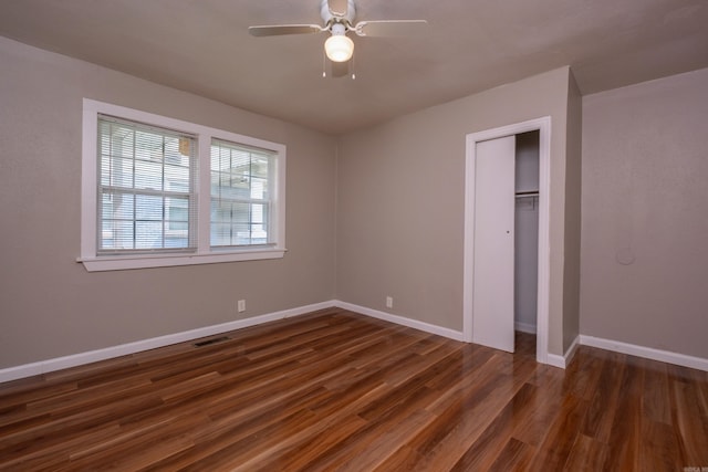 1318-1320 S Summit St, Little Rock, AR 72202 - unfurnished bedroom featuring dark wood finished floors, baseboards, a closet, and ceiling fan