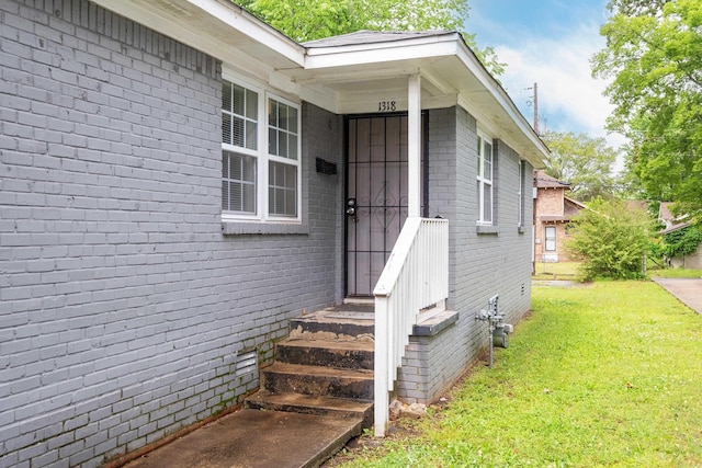 1318-1320 S Summit St, Little Rock, AR 72202 - view of exterior entry with brick siding and a lawn