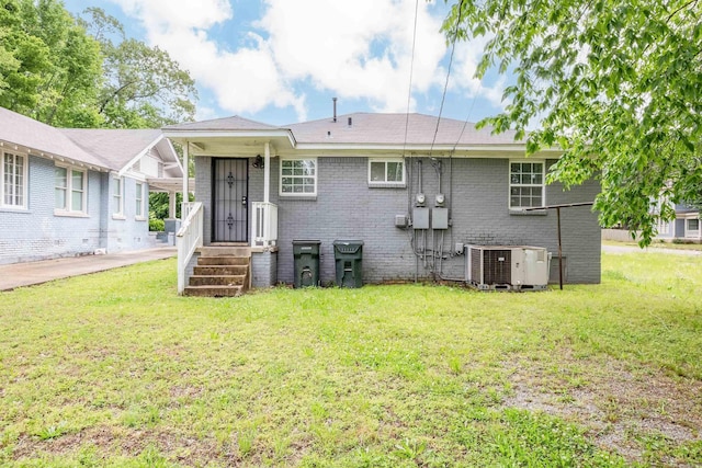 1318-1320 S Summit St, Little Rock, AR 72202 - rear view of house featuring central air condition unit, a lawn, and brick siding