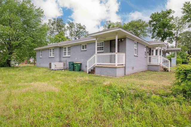 1318-1320 S Summit St, Little Rock, AR 72202 - rear view of house with crawl space, brick siding, covered porch, and central air condition unit