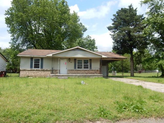 1308 Shelby, Sikeston, MO 63801 - view of front of home with driveway, brick siding, an attached carport, a front lawn, and a porch