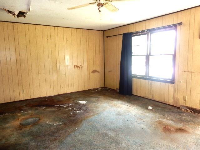 1308 Shelby, Sikeston, MO 63801 - empty room with a ceiling fan and wooden walls