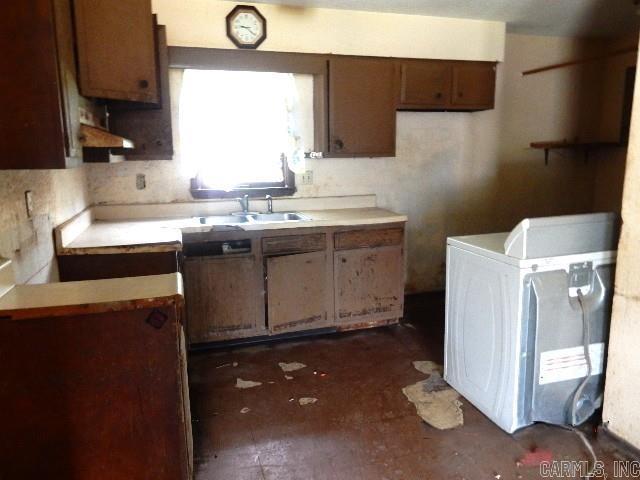 1308 Shelby, Sikeston, MO 63801 - kitchen featuring a sink, range hood, light countertops, and washer / dryer
