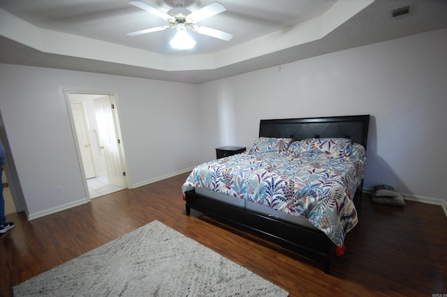 12601 Woodbury Dr, Little Rock, AR 72211 - bedroom featuring wood finished floors, baseboards, a tray ceiling, and a ceiling fan