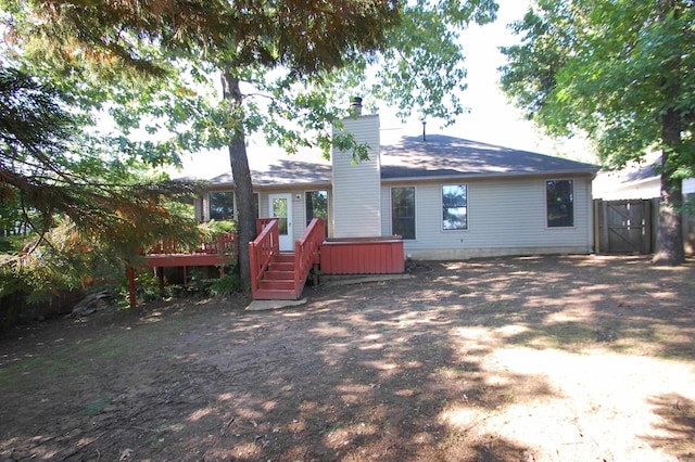 12601 Woodbury Dr, Little Rock, AR 72211 - back of house featuring a wooden deck, a chimney, and fence