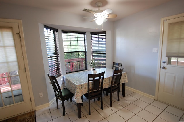 12601 Woodbury Dr, Little Rock, AR 72211 - dining space featuring baseboards, a ceiling fan, and light tile patterned floors