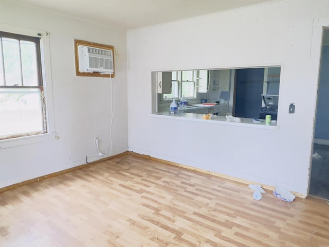 37 Maple St, Melbourne, AR 72556 - unfurnished room with a wall mounted air conditioner, wood finished floors, and baseboards