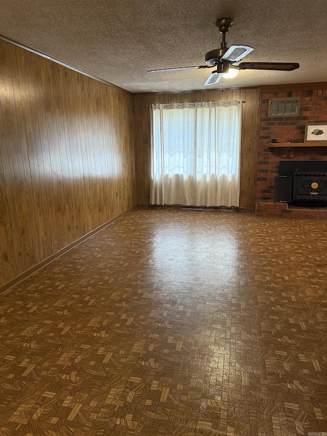 514 S Sawmill Rd, Searcy, AR 72143 - unfurnished living room with a ceiling fan, wood walls, a textured ceiling, and baseboards