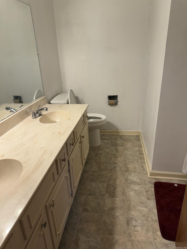 514 S Sawmill Rd, Searcy, AR 72143 - bathroom featuring toilet, baseboards, and double vanity