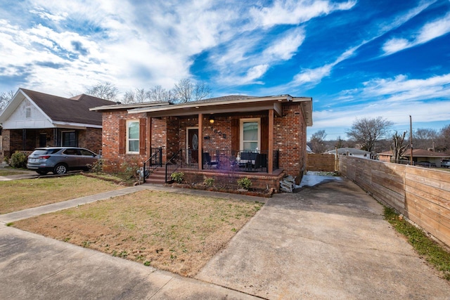 1608 S Cross St, Little Rock, AR 72206 - view of front of property featuring brick siding, a porch, and concrete driveway