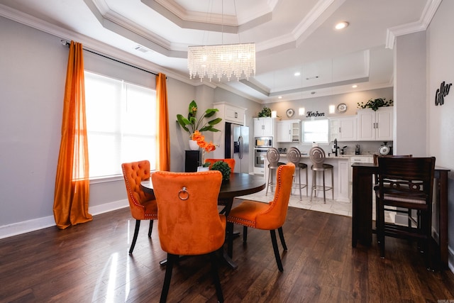1608 S Cross St, Little Rock, AR 72206 - dining space with a tray ceiling, ornamental molding, a chandelier, dark wood finished floors, and baseboards