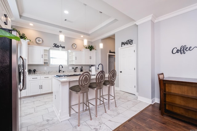 1608 S Cross St, Little Rock, AR 72206 - kitchen with appliances with stainless steel finishes, light marble finish flooring, a kitchen bar, white cabinetry, and ornamental molding