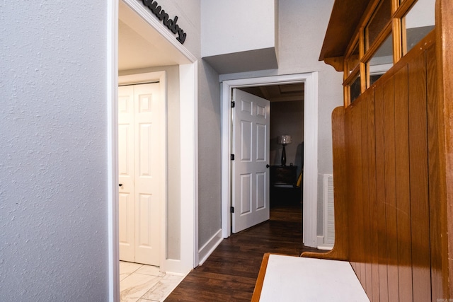 1608 S Cross St, Little Rock, AR 72206 - hall with a textured wall, wood finished floors, and baseboards