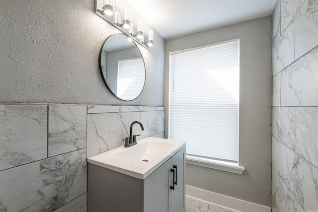 1608 S Cross St, Little Rock, AR 72206 - bathroom with marble finish flooring, tile walls, and vanity