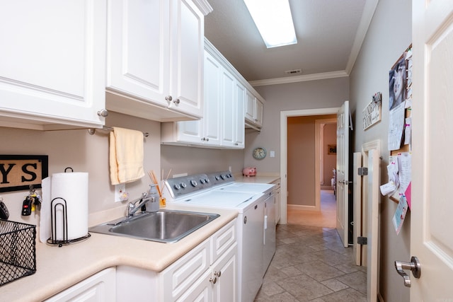 5718 Mediterranean Blvd, Benton, AR 72019 - clothes washing area featuring cabinet space, washing machine and clothes dryer, ornamental molding, and light stone finish flooring