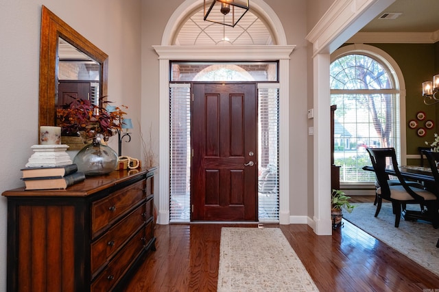 5718 Mediterranean Blvd, Benton, AR 72019 - entrance foyer with dark wood-style flooring, a chandelier, baseboards, and ornamental molding