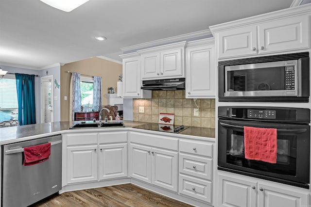 kitchen featuring black appliances, a sink, ornamental molding, white cabinetry, and under cabinet range hood