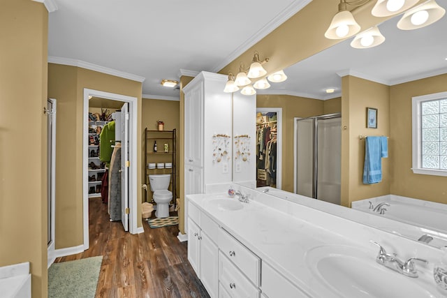 bathroom featuring a stall shower, wood finished floors, toilet, a spacious closet, and crown molding