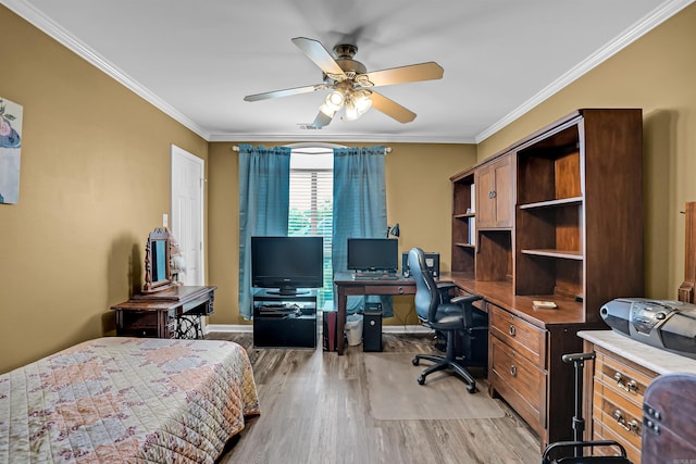 bedroom featuring light wood-type flooring, a desk, crown molding, baseboards, and a ceiling fan