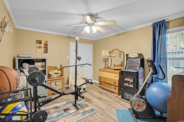 workout room featuring ceiling fan, ornamental molding, wood finished floors, and baseboards