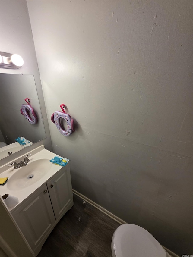 2113AND2115 Scotty Ct, Little Rock, AR 72204 - bathroom featuring toilet, vanity, wood finished floors, and baseboards