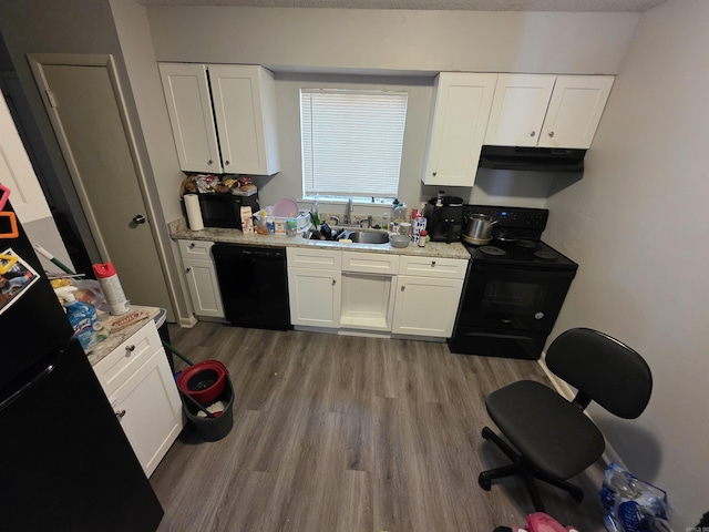 2113AND2115 Scotty Ct, Little Rock, AR 72204 - kitchen with black appliances, under cabinet range hood, a sink, wood finished floors, and white cabinetry