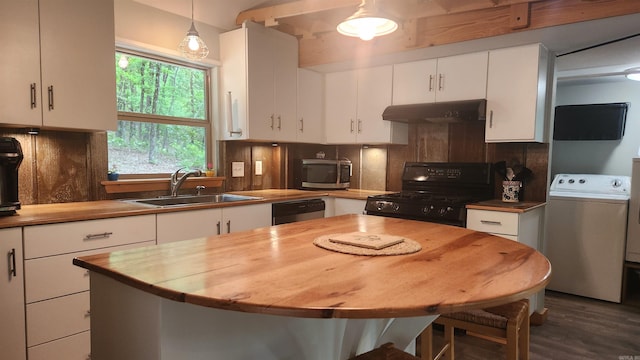 180 Herschel B Guinn Rd, Story, AR 71970 - kitchen with black gas range, under cabinet range hood, washer / dryer, stainless steel microwave, and a sink
